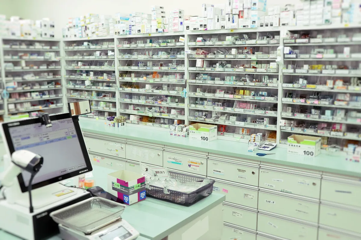 はるひ薬局の調剤室。医薬品の棚と調剤台